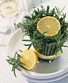 Lemon on arrangement of herbs and bamboo as table decoration