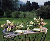Laid table with arrangements of lilies, astilbe, Ageratum