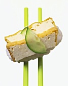 Nigiri-sushi with baked tofu strips and slice of cucumber