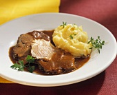 Two slices of leg of lamb with mashed potato