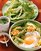 Pan-cooked vegetable dish with quinoa, fried egg, salad & ajvar