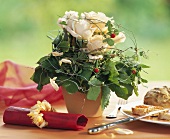 Table arrangement of white roses & wild strawberry runners