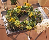 Tray with wreath of ivy, hydrangeas, Doronicum