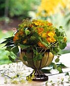 Summer bouquet of marigolds, vine tendrils, dill flowers