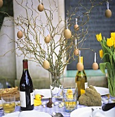 A laid table decorated for Easter with wine