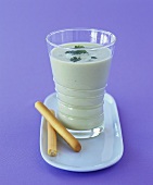 Avocado soup in glass with grissini
