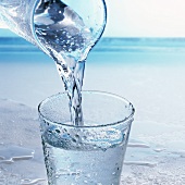 Wasser wird in ein Glas eingegossen