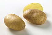Two half and one whole potato, variety 'Christa'