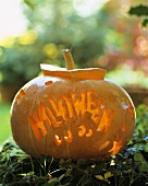 The word ‘Halloween’ carved in a pumpkin