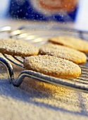 Biscuits being dusted with icing sugar