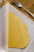 Rolled out pastry on baking parchment