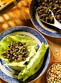 Minced beef with cashew nuts on lettuce leaf