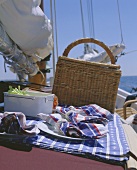 Picnic basket and picnic things on yacht at seaside