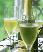 Champagne bottle with several half-full glasses in carrier
