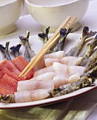Various raw fish fillets & shrimps with chopsticks