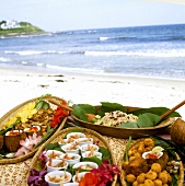 Verschiedene Gerichte auf Korbplatten am Karibik-Buffet