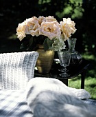 Peach Roses in Vase next to Wicker Chair