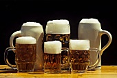 Various full beer tankards on beer table