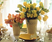 Yellow and red & yellow tulips in  yellow vase on Easter table