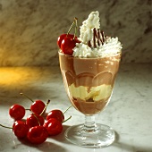 Chocolate iced coffee with ice cream, cherries, cream