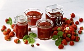 Strawberries and jars of strawberry jam