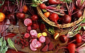Various types of beetroot in and beside a basket