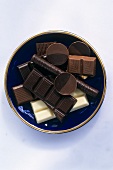 Pieces of white and dark chocolate on plate