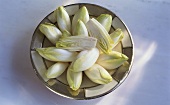 Chicory, whole and halved, on a plate