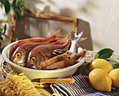 Still life with fish, shrimps, mussels, pasta & lemons