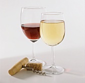 A glass each of red & white wine, corks & corkscrew