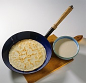 Crepe in Frying Pan with Batter on the Side