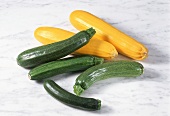Two yellow and four green whole courgettes