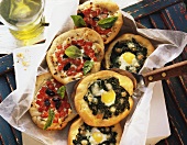 Small spinach pizzas with egg & tomato pizzas with ricotta