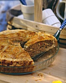 Mince and mushroom quiche with a piece lifted up