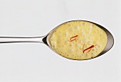 Orange & saffron sauce with saffron threads on spoon