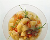Bouillon potatoes with tomatoes and chives