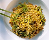 Chinese noodles with leeks and chopped peanuts