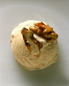 A scoop of walnut ice cream with walnut brittle