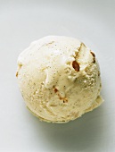 A scoop of walnut ice cream with chopped walnuts