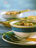 Potato and cream cheese soup with croutons and chives