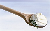 Crème fraiche on a wooden cooking spoon
