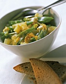 Curried beans with raisins & potatoes in white bowl