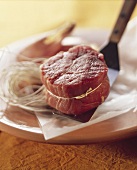 Beef fillet (tied with kitchen string) on spatula