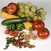 Various vegetables, fruit and nuts on light background