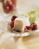 Yoghurt mousse, cut into, with red wine cherries