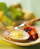 Lemon tartlet with berry ragout on plate