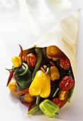Various types of peppers and chili peppers in paper bag
