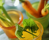 Spinach, carrots and celery in coloured mugs