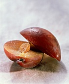 Half a plum with stone and drops of water