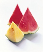 Two slices of watermelon and one slice of sweet melon